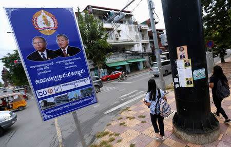 Posters of the Cambodian People's Party (CPP) and FUNCINPEC Party are seen along a street in Phnom Penh, Cambodia, July 17, 2018. REUTERS/Samrang Pring