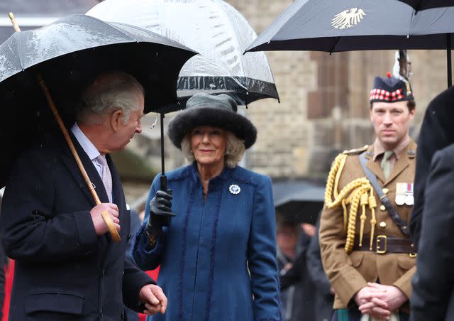 <p>Christian Charisius/picture alliance via Getty</p> King Charles, Queen Camilla and Johnny Thompson in Germany.