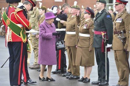 Britain's Queen Elizabeth presents leeks to soldiers from The Royal Welsh Regiment, at Lucknow Barracks during a visit to mark St David's Day, in Tidworth, Britain March 3, 2017. REUTERS/Ben Birchall