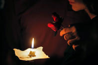 <p>A young man and woman hold two roses and a candle during a candlelight vigil for the victims of the Wednesday shooting at Marjory Stoneman Douglas High School, in Parkland, Fla., Thursday, Feb. 15, 2018. (Photo: Gerald Herbert/AP) </p>