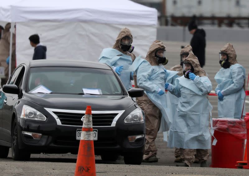 Members of the Colorado Air National Guard test people who suspect they are infected with coronavirus disease (COVID-19), at a drive-thru testing station, in Denver