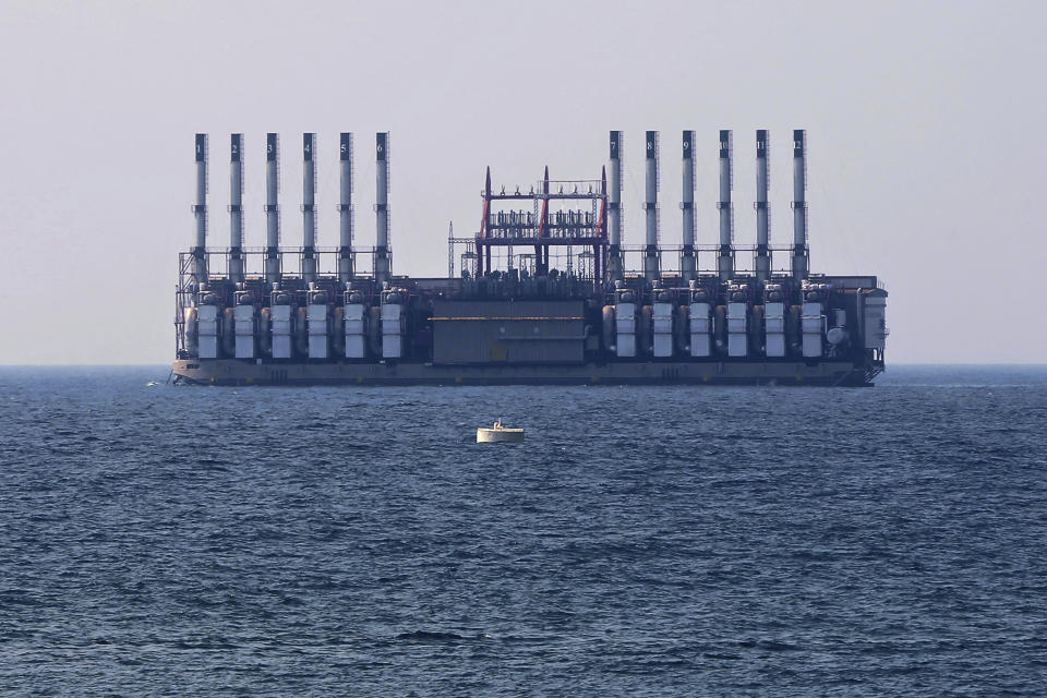 FILE - In this July 16, 2018 file photo, a floating power station waits off the coast at Jiyeh, south of Beirut, Lebanon. The Turkish company, Karpowership, supplying electricity to Lebanon from two power barges off the coast of Beirut said Friday, Oct. 1, 2021, it has halted supplies after its contract with the Lebanese state electricity company expired. (AP Photo/Bilal Hussein, File)