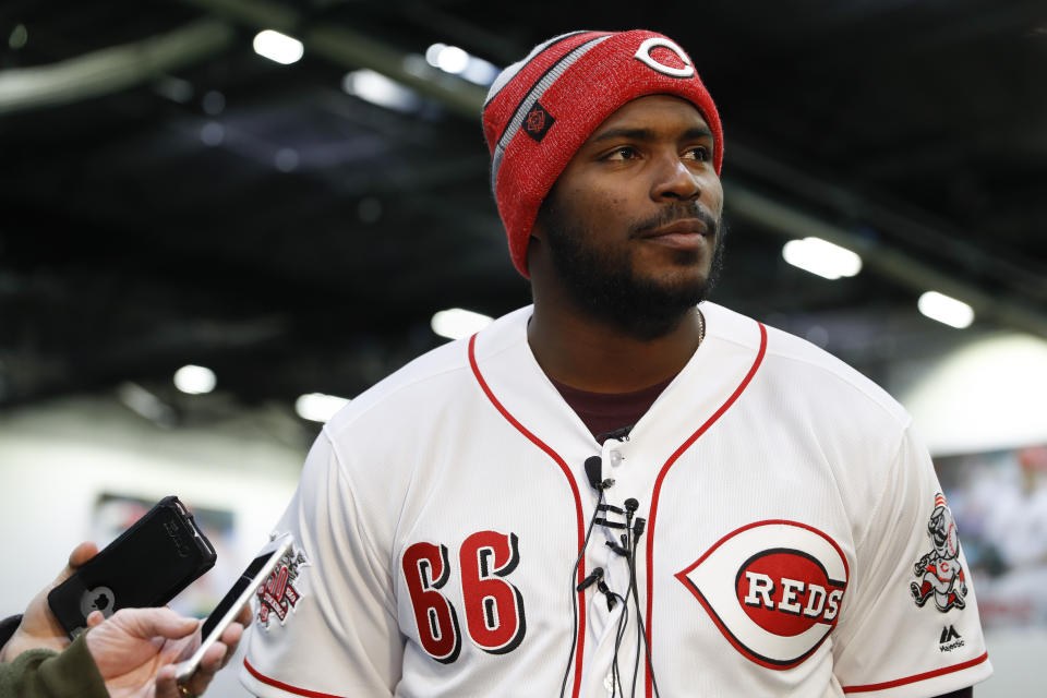 Cincinnati Reds Yasiel Puig takes questions from reporters during a media availability at the P&G MLB Cincinnati Reds Youth Academy, Wednesday, Jan. 30, 2019, in Cincinnati. (AP Photo/John Minchillo)