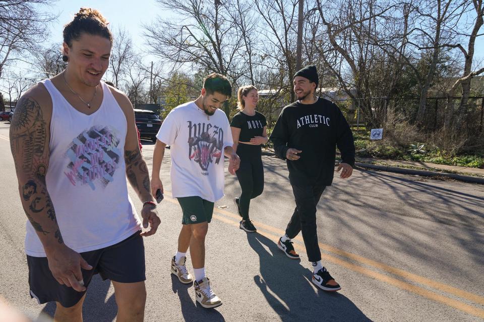 Bryan Bell, from left, Rick "Rick from Texas" Padilla, Samantha Devine and Tony Ramos go on a cool down walk after their workout Feb. 9 at East Austin Athletic Club. Ramos is the co-owner of the full-service gym, where he's built a community for more than just workouts.