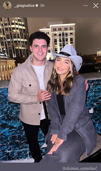 Gia Giudice and Christian Carmichael posing together on a rooftop.