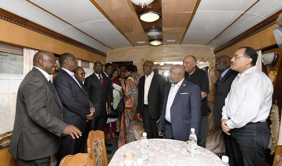 In this photo provided by the South African Government Communications and Information Services (GCIS) South African President Cyril Ramaphosa, left, and other delegates travel on a train towards Kyiv, from Warsaw, Poland, Thursday, June 15, 2023. Ramaphosa is taking part in the African Peace Mission aimed at a peaceful resolution of the conflict between Ukraine and Russia. (South African Government Communication and Information Services via AP)