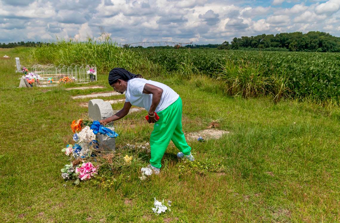 Arthur Badger clears flowers from his wife’s grave in a rural cemetery in Allendale. Donna Hay Badger died in a car crash in 2011 with a UPS truck.