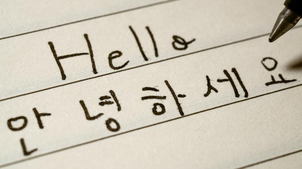 Hello and Korean words written out on piece of paper.