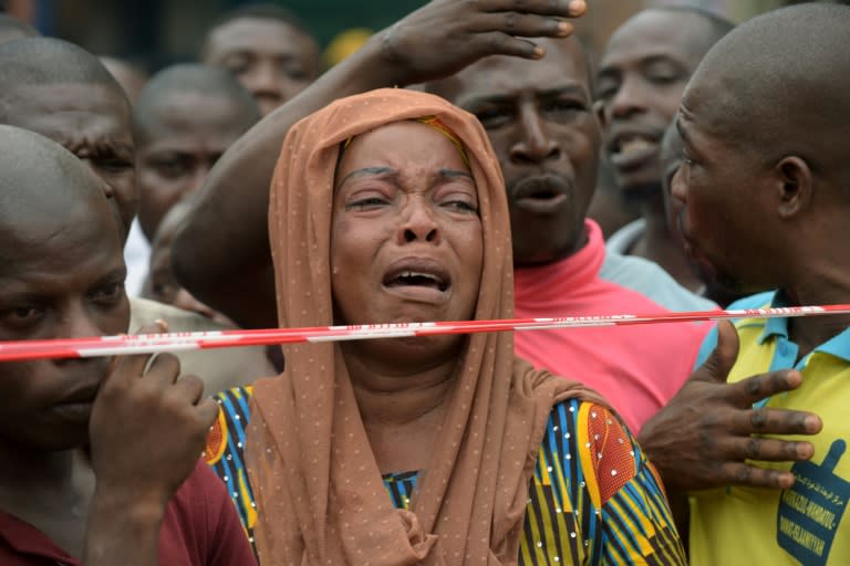 A woman cries at the scene of a deadly four-storey building collapse in Lagos on July 26, 2017