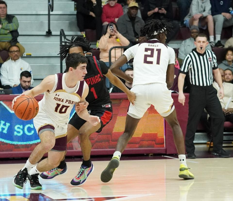 Iona Prep's Blaise New works around a screen from Alexander Bryant in the fourth quarter of the Gaels' 44-42 win over Stepinac at Iona University on Feb. 11, 2023.