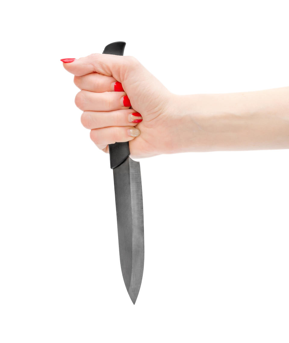 Woman's hand holding a knife.