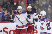 New York Rangers' Jimmy Vesey (26) celebrates his goal with teammates Mika Zibanejad (93) and Chris Kreider (20)during the first period of an NHL hockey game against the Ottawa Senators, Wednesday, Nov. 30, 2022 in Ottawa, Ontario. (Patrick Doyle/The Canadian Press via AP)