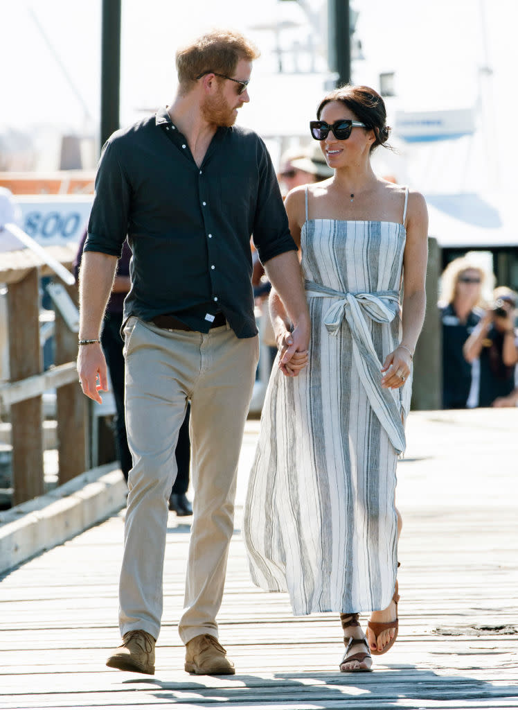 favorite fashion clothing brands meghan markle wears, Prince Harry and Meghan Markle in Fraser Island, Australia in 2018, Reformation, striped linen dress, California