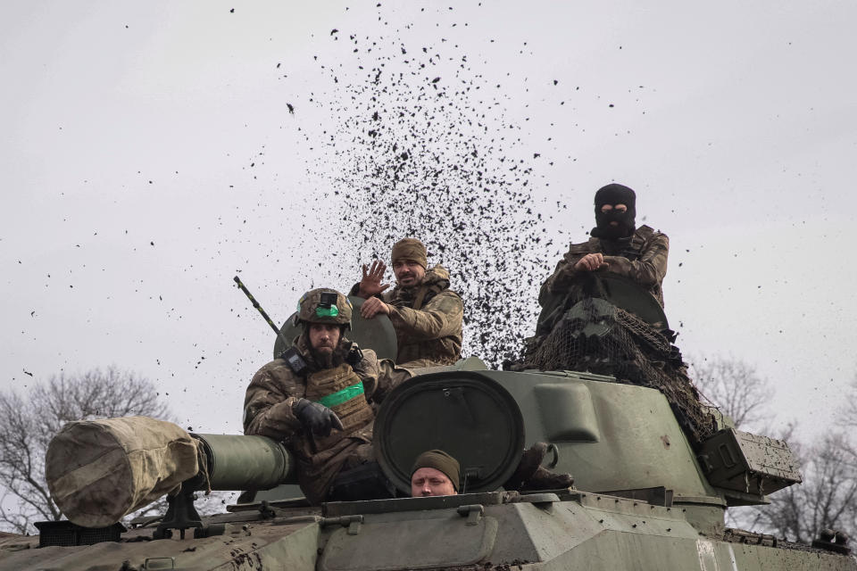 Ukrainian service members ride a self-propelled howitzer, as Russia's attack on Ukraine continues, near the frontline city of Bakhmut, Ukraine February 27, 2023. REUTERS/Yevhen Titov