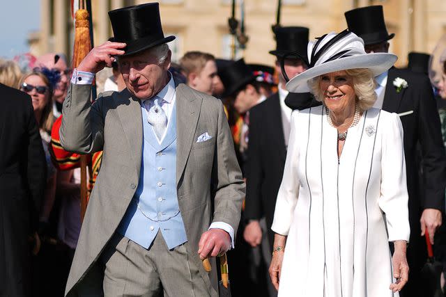 <p>JORDAN PETTITT/POOL/AFP via Getty</p> King Charles and Queen Camilla at the Buckingham Palace garden party on May 8, 2024.