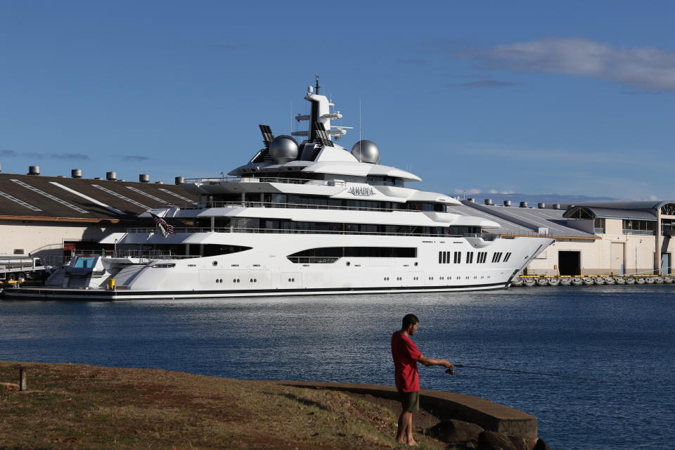 The superyacht Amadea is moored in Honolulu on Thursday, June 16, 2022. The Russian-owned superyacht seized by the United States arrived in Honolulu Harbor flying an American flag after the U.S. last week won a legal battle in Fiji to take the $325 million vessel. (AP Photo/Audrey McAvoy)