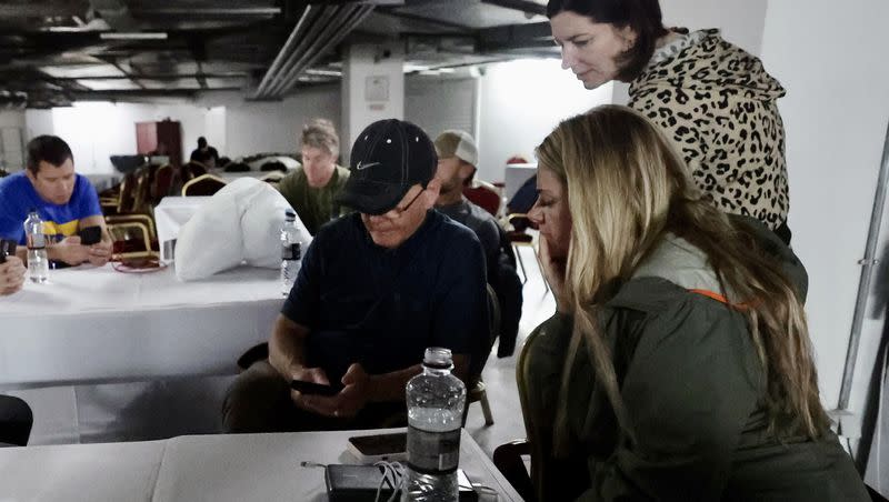 Utah Senate President Stuart Adams, R-Layton, To Ukraine With Love founder Svitlana Miller, center, and Wander COO Tiffany Vail consult the Signal and Air Alert! apps for updates on air strikes near the Kyiv Oblast (region).  Part of the Utah trade delegation to Ukraine, the three were joined by others at the shelter on Wednesday, May 3, 2023.