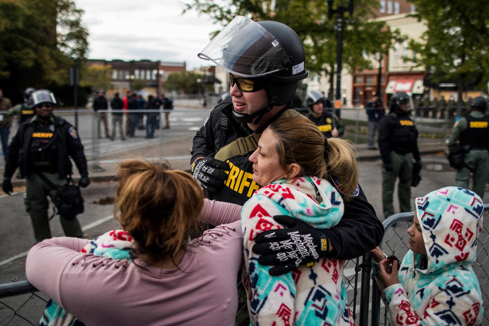 <p>Krystal Dunnaway of Nashville hugs an officer after a “White Lives Matter” rally on Oct. 28, 2017 in Murfreesboro, Tenn. (Photo: Joe Buglewicz/Getty Images) </p>