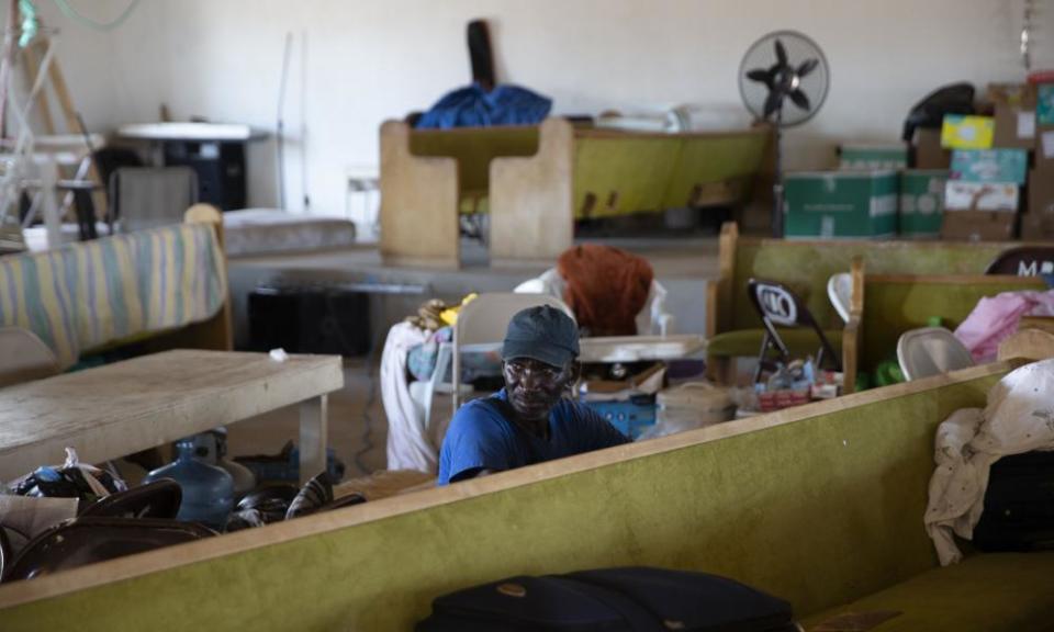 A man rests at the Full Gospel church in Sand Banks, 9 September 2019 in Great Abaco Island, Bahamas. The Haitians that have stayed struggle to survive with little help from foreign aid agencies.