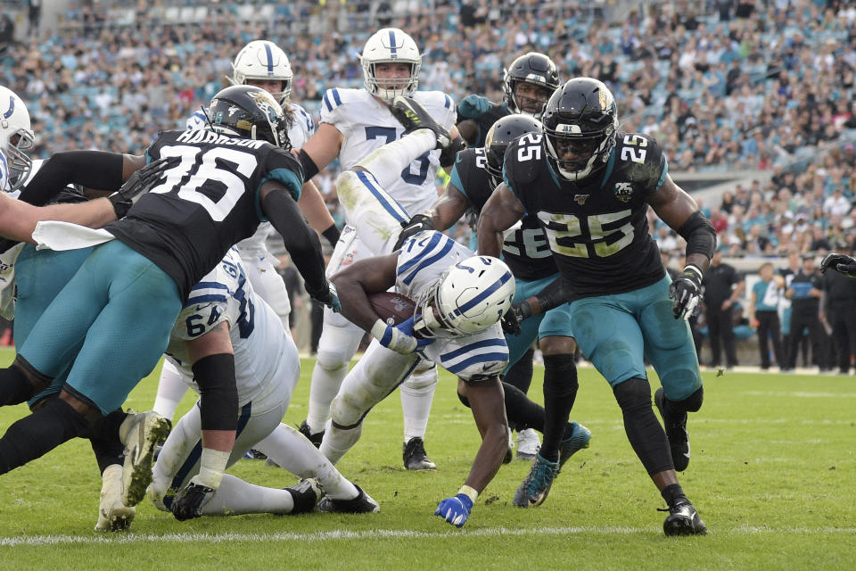 Indianapolis Colts running back Marlon Mack, center, scores on a 5-yard touchdown run past the Jacksonville Jaguars defense during the first half of an NFL football game, Sunday, Dec. 29, 2019, in Jacksonville, Fla. (AP Photo/Phelan M. Ebenhack)