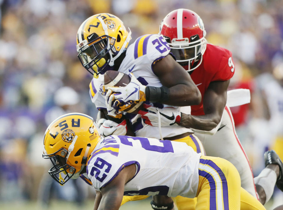 LSU safety John Battle (26), with assistance from cornerback Greedy Williams (29), intercepts a pass from Georgia quarterback Jake Fromm intended for wide receiver Jeremiah Holloman, rear, during the fourth quarter of an NCAA college football game Saturday, Oct. 13, 2018, in Baton Rouge, La. (Bob Andres/Atlanta Journal Constitution via AP)