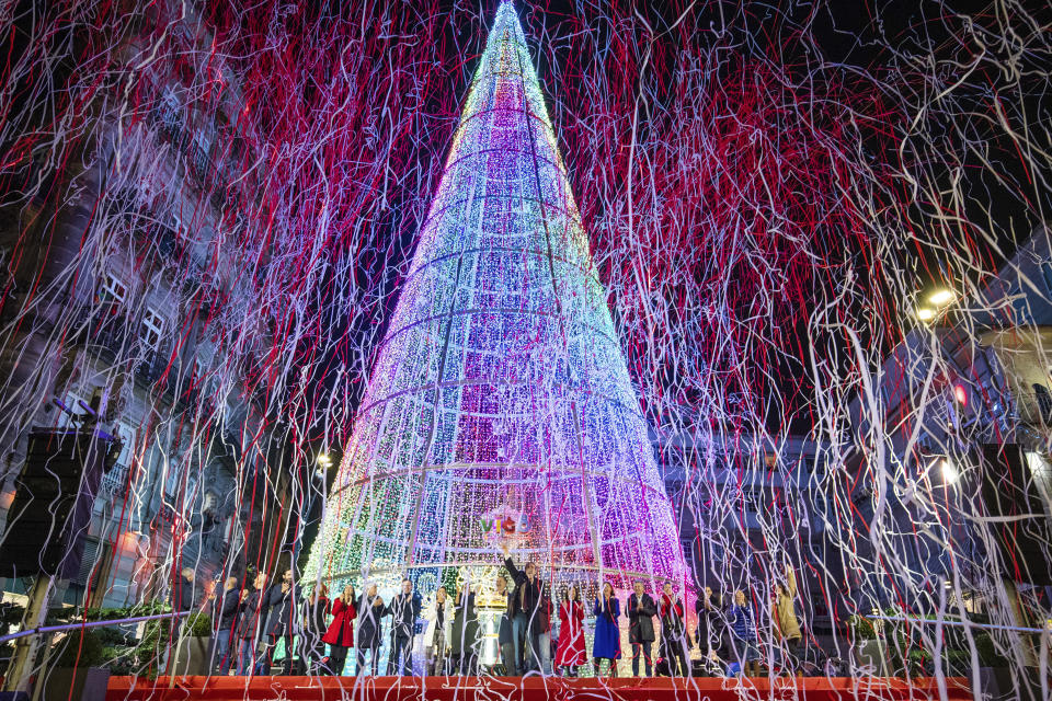 FILE - Local authorities inaugurate the Christmas lighting in the streets of Vigo, Spain, Nov. 19, 2022. In cities across Europe, officials are wrestling with a choice this Christmas. Dim lighting plans to send a message of energy conservation and solidarity with citizens squeezed by both higher energy costs and inflation or let the lights blaze in a message of defiance after two years of pandemic-suppressed Christmas seasons, creating a mood that retailers hope loosen holiday purses. (AP Photo/Lalo R. Villar, File)