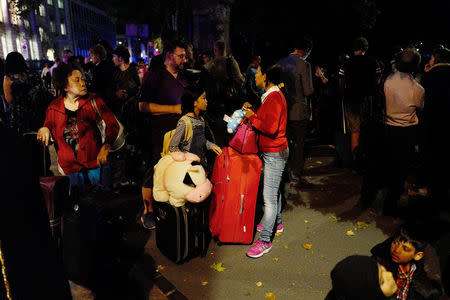 Commuters are seen outside Euston Station after police evacuated the area following a security alert in London, Britain, August 29, 2017. REUTERS/Tolga Akmen