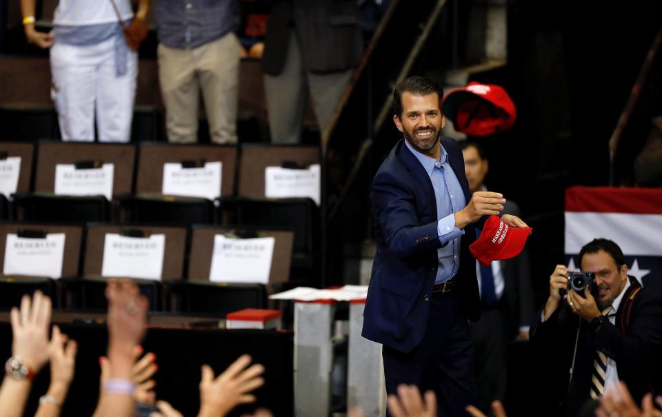 Donald Trump Jr. throws Make America Great Again hats to the crowd during a rally at U.S. Bank Arena Thursday, August 1, 2019, in downtown Cincinnati. 