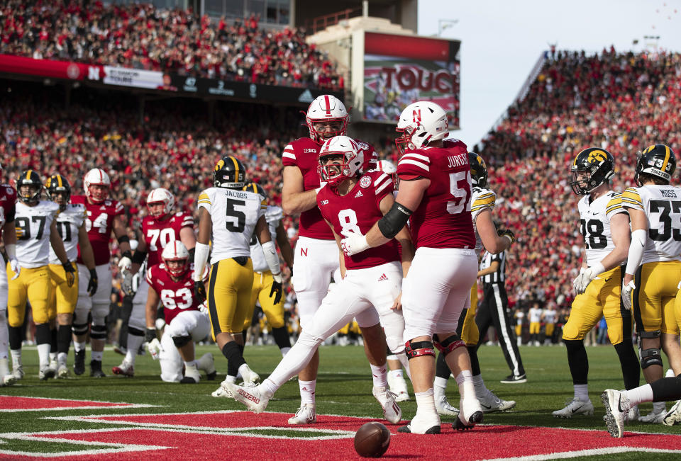 Nebraska quarterback Logan Smothers (8) celebrates with Austin Allen (11) and Cam Jurgens (51) after scoring a touchdown against Iowa during the first half of an NCAA college football game Friday, Nov. 26, 2021, at Memorial Stadium in Lincoln, Neb. (AP Photo/Rebecca S. Gratz)