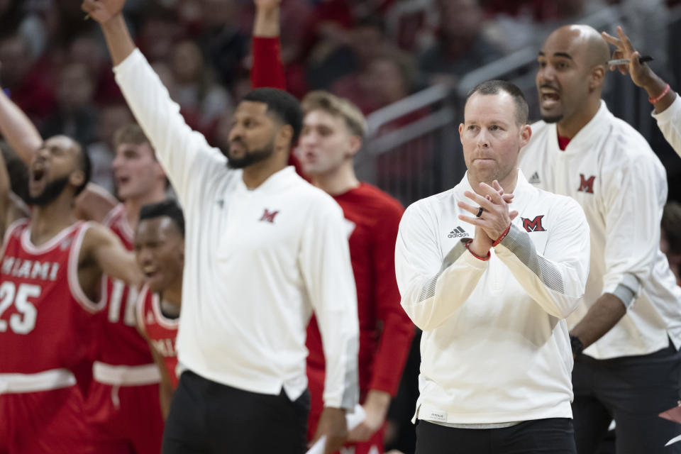Miami (Ohio) head coach Travis Steele, front right, reacts during the first half of an NCAA college basketball game against Indiana, Sunday, Nov. 20, 2022, in Indianapolis. (AP Photo/Marc Lebryk)