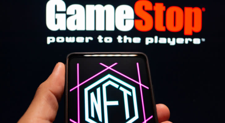 The GameStop (GME) logo above the NFT logo on a smartphone.