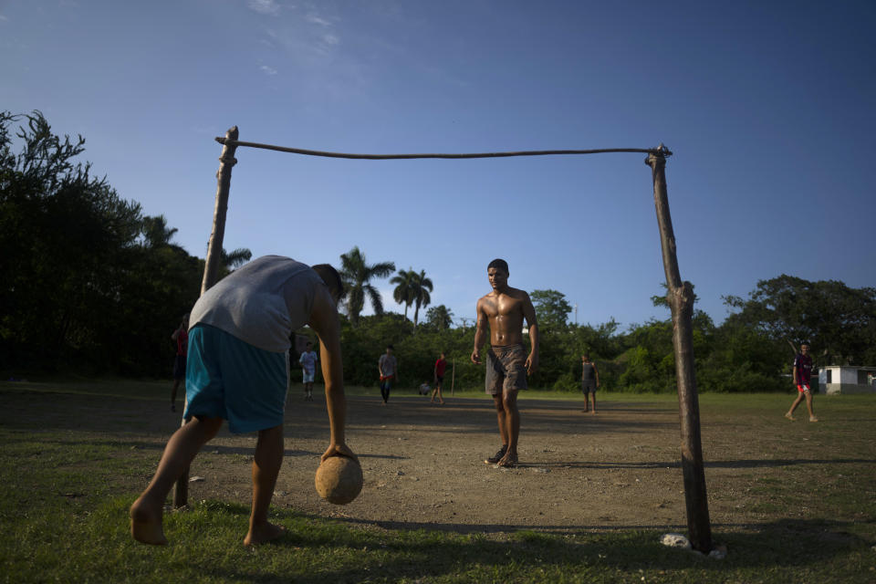 Locals play soccer on an old baseball field in the Santa Fe municipality of Guanabacoa east of Havana, Cuba, Saturday, Oct. 15, 2022. Soccer coaches across Cuba are training dozens of players as part of a new program to elevate the sport's profile and status in a country that last qualified for the FIFA World Cup in 1938. (AP Photo/Ramon Espinosa)