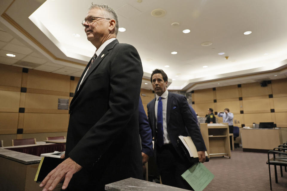 Former Marjory Stoneman Douglas High School School Resource Officer Scot Peterson, left, leaves the courtroom with his defense lawyer Mark Eiglarsh following a hearing in his case at the Broward County Courthouse in Fort Lauderdale, Fla., Monday, May 22, 2022. Broward County prosecutors charged Peterson, a former Broward Sheriff's Office deputy, with criminal charges for failing to enter the 1200 Building at the school and confront the shooter, Nikolas Cruz, during a mass shooting at the Parkland high school five years ago. (Amy Beth Bennett/South Florida Sun-Sentinel via AP, Pool)