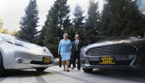 FILE - In this Oct. 24, 2013, file photo, Mary Nichols, chairwoman of the California Air Resources Board, walks between a pair of zero-emission vehicles displayed in Sacramento, Calif. Nichols' term leading CARB ends in December 2020. She's held the role since 2007 after an earlier stint as chair in the early 1980s. Nichols is viewed as a leading contender to be named as Biden’s administrator for the Environmental Protection Agency. (AP Photo/Rich Pedroncelli, File)