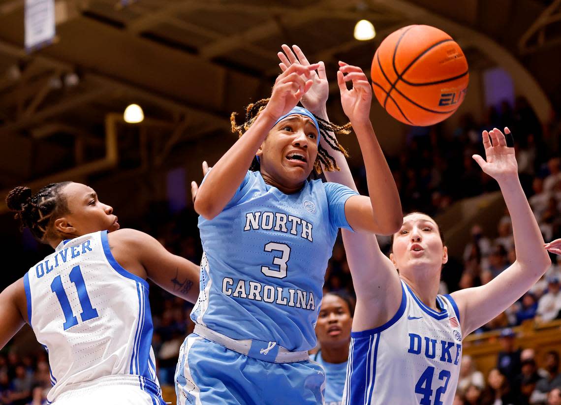 Duke’s Jordyn Oliver and Mia Heide battle North Carolina’s Kennedy Todd-Williams for a loose ball during the second half of the Tar Heels’ 45-41 win over Duke on Sunday, Feb. 26, 2023, at Cameron Indoor Stadium in Durham, N.C.