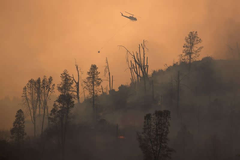 Helicopter releases water on secition of LNU Lightning Complex Fire near Middletown, California