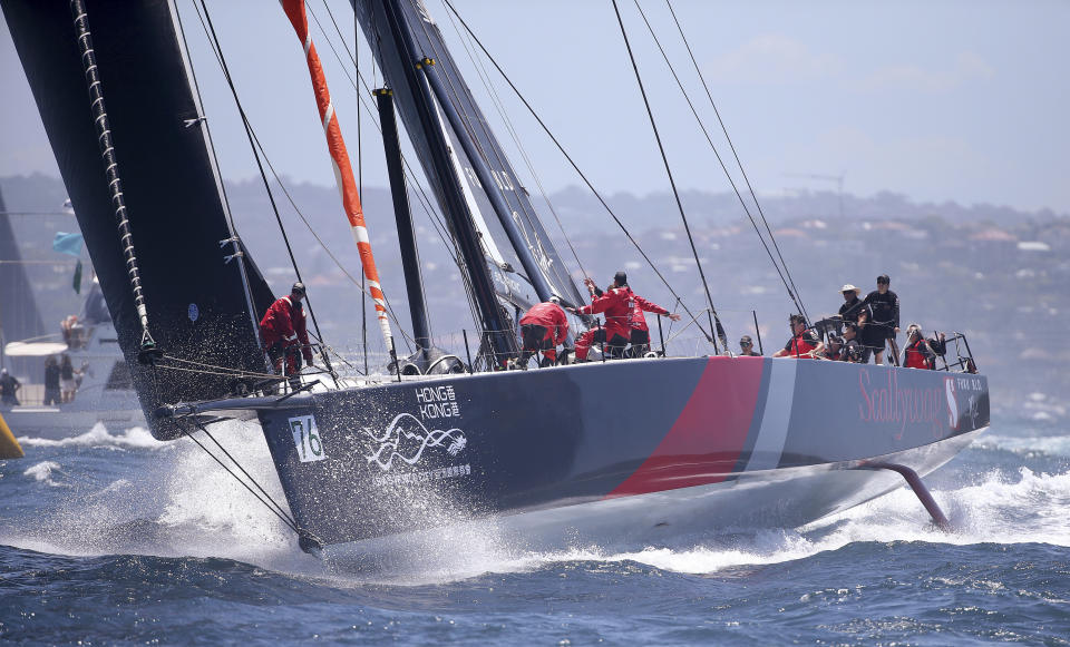 The Hong Kong maxi yacht Scallywag reaches the heads during the start of the Sydney Hobart yacht race in Sydney, Wednesday, Dec. 26, 2018. The 630-nautical mile race has 85 yachts starting in the race to the island state of Tasmania. (AP Photo/Rick Rycroft)