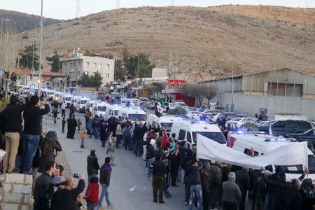 A convoy of ambulances carrying more than 125 fighters from the besieged rebel-held Syrian town of Zabadani arrive at the Masnaa border crossing between Lebanon and Syria, December 28, 2015. REUTERS/Mohamed Azakir