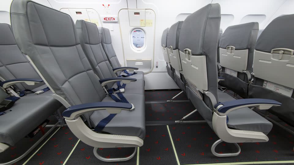 During safety briefings, passengers are told the location of emergency exits and instructed to leave all their belongings behind in the event of an emergency. - Wirestock/iStockphoto/Getty Images