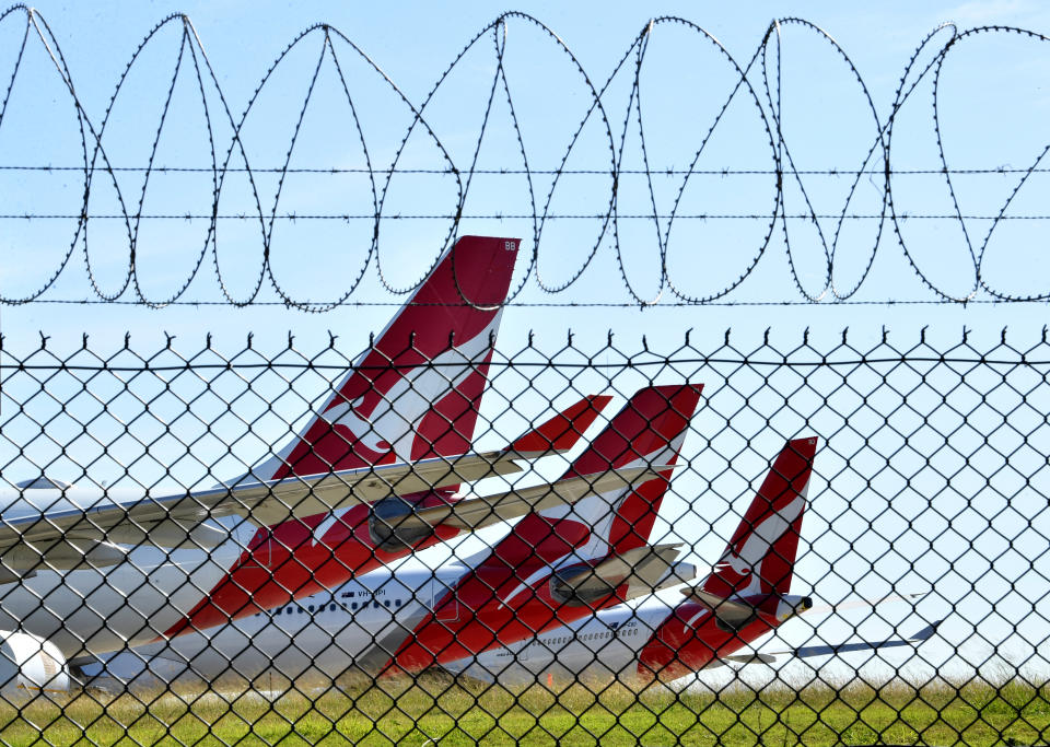 Grounded Qantas aircraft are seen parked at Brisbane Airport.