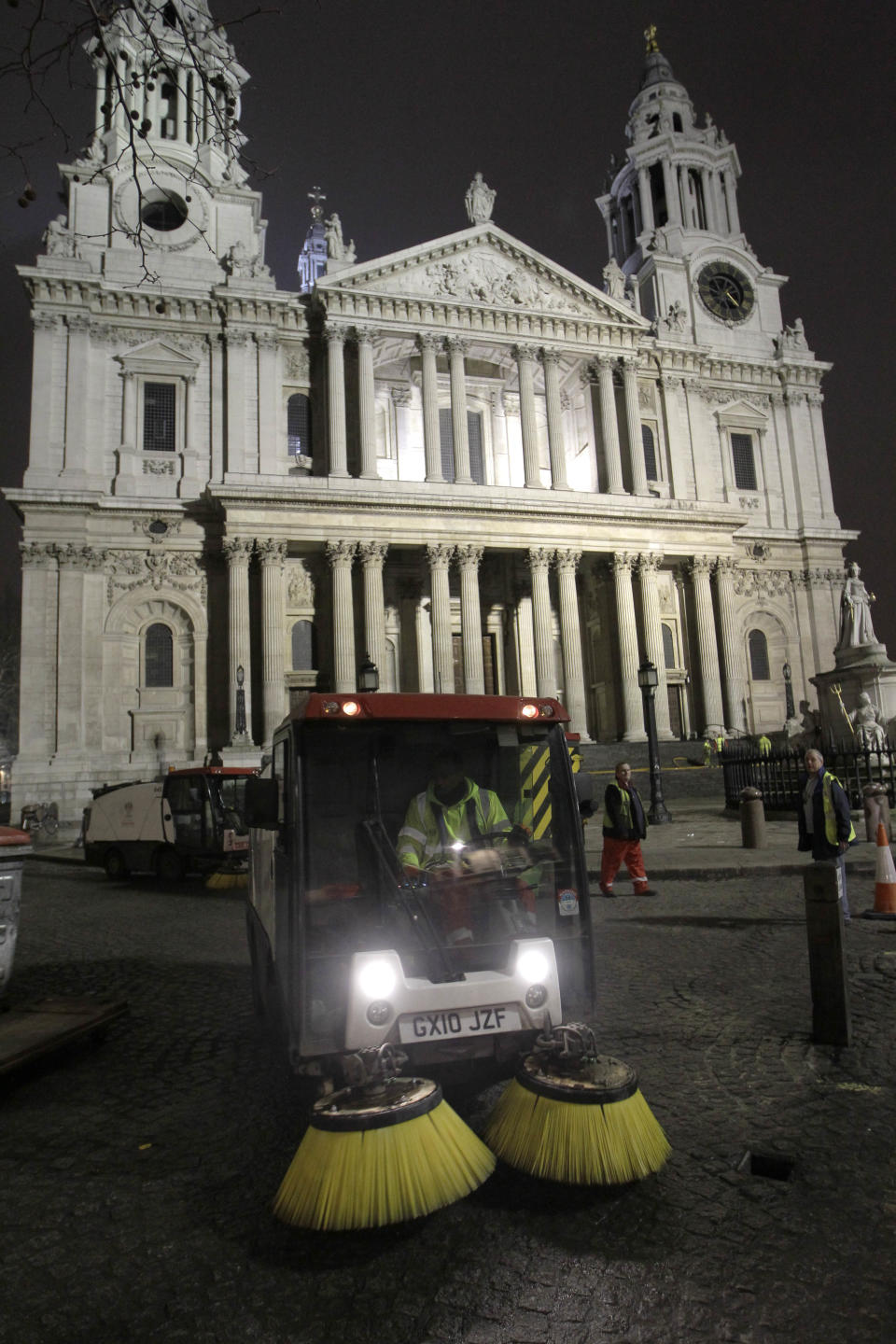 Workers clean the area outside St Paul's Cathedral in London after bailiffs moved in to remove tents from the Occupy London camp, Tuesday, Feb. 28, 2012. Occupy London was last week refused permission to appeal against a High Court decision to allow their eviction to proceed. (AP Photo/Sang Tan)