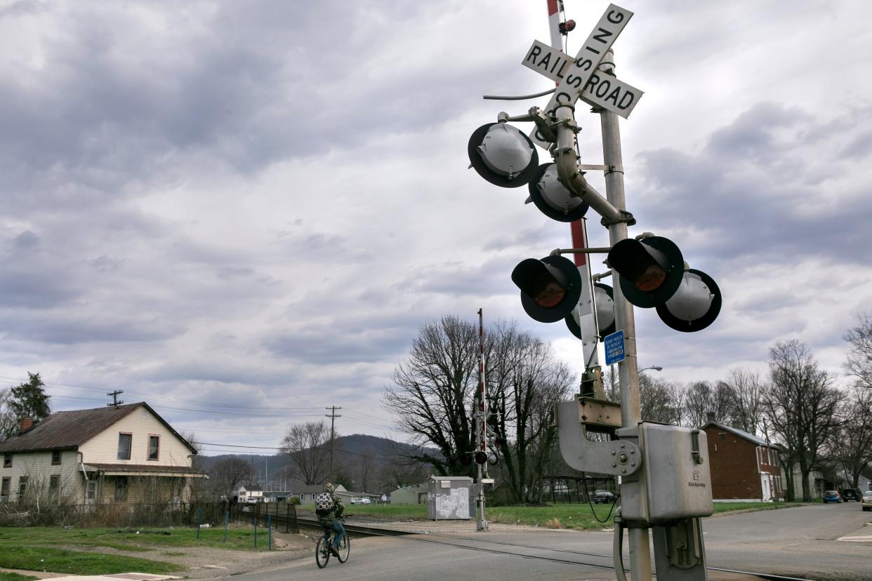A person riding their bicycle crosses over the railroad tracks on Mar. 14, 2024, in Chillicothe, Ohio.