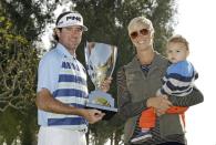 Bubba Watson holds the winner's trophy with his wife Angie and son Caleb after his victory in the Northern Trust Open golf tournament at Riviera Country Club in the Pacific Palisades area of Los Angeles, Sunday, Feb. 16, 2014. Watson carded a 15-under-par 269, two strokes ahead of the second-place finisher. (AP Photo/Reed Saxon)