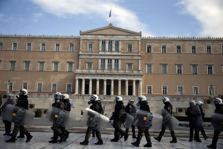Riot police walk past the parliament building while guarding an anniversary rally marking the 2008 police shooting of 15-year-old student, Alexandros Grigoropoulos, in Athens, Greece, December 6, 2016. REUTERS/Alkis Konstantinidis
