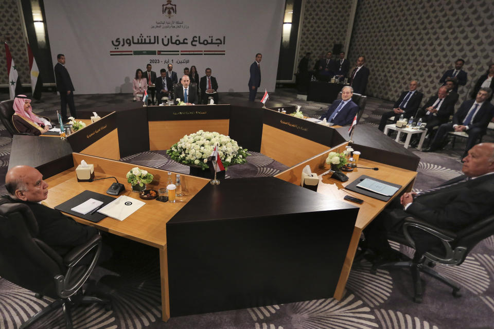 Jordan's Foreign Minister Ayman Safadi, center background, Saudi Arabia's Foreign Minister Prince Faisal bin Farhan Al Saud, second left, Iraqi Foreign Minister Fouad Hussein, left, Egyptian Foreign Minister Sameh Shoukri, right, and Syrian Foreign Minister Faisal Mekdad, second right, attend a regional consultative meeting in Amman, Jordan, Monday, May 1, 2023. Regional leaders are meeting in Jordan to discuss Syria's return to the Arab fold and a Jordanian proposal to reach a "political solution" to the Syrian conflict. The talks, attended by the top diplomats of Jordan, Syria, Saudi Arabia, Iraq and Egypt, kicked off Monday with a meeting between Jordanian Foreign Minister Ayman Safadi and Syrian Foreign Minister Faisal Mekdad. (AP Photo/Raad Adayleh)