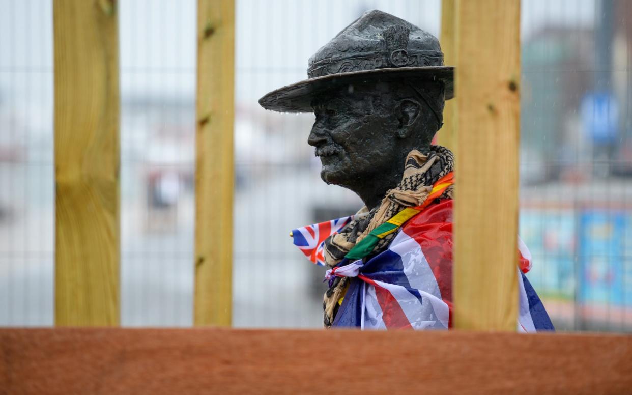 Workmen board up the Lord Baden-Powell statue in Poole - Finnbarr Webster/Getty Images