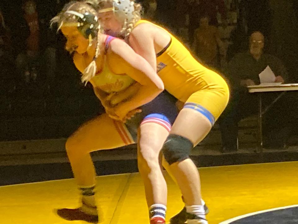 Brooke Dylon of the Crawford Wrestling Club (blue singlet) tries to break the hold of Canon-McMillan's Chloe Ault during their 148-pound match of Tuesday's all-girls wrestling dual at Saegertown. Ault pinned Dylon, but Crawford won the historic event 48-27.