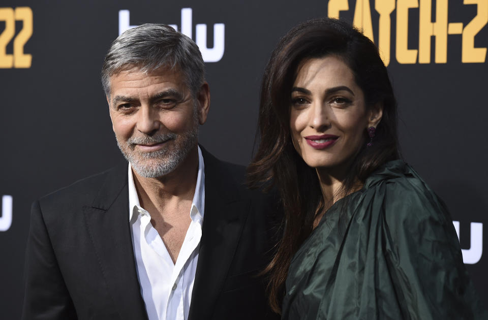 George Clooney and Amal Clooney arrive at the Los Angeles premiere of "Catch-22" at TCL Chinese Theatre on Tue., May 7, 2019. (Photo by Jordan Strauss/Invision/AP)