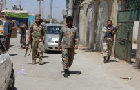 Afghan security personnel patrol during fighting between Taliban and Afghan security forces in Kunduz city, north of Kabul, Afghanistan, Thursday, June 24, 2021. Taliban gains in north Afghanistan, the traditional stronghold of the country's minority ethnic groups who drove the insurgent force from power nearly 20 years ago, has driven a worried government to resurrect militias whose histories have been characterized by chaos and widespread killing. (AP Photo/Samiullah Quraishi)