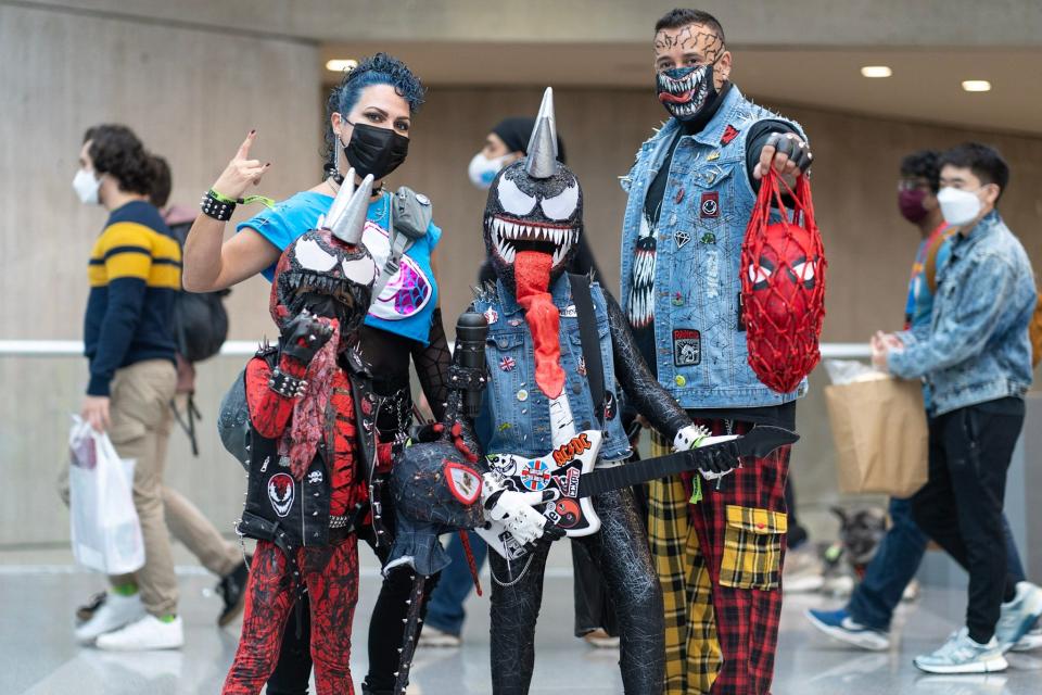 A group of four cosplayers dressed as rocker versions of Venom at New York Comic Con 2021.